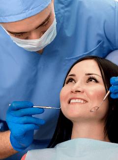 dentist over patient