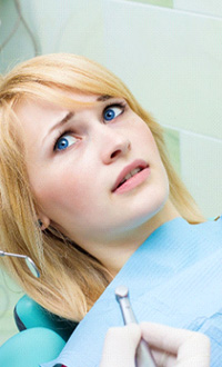 Woman afraid in the dental chair