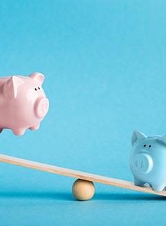 Piggy banks on balance scale