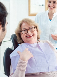 Older woman talking to dentist about dentures in Topeka & Silver Lake, KS