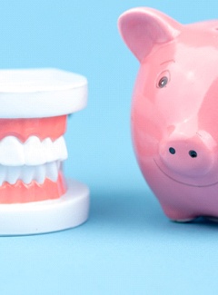 Piggy bank next to dentures in Topeka & Silver Lake, KS