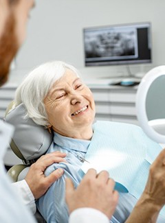 patient smiling in dental mirror