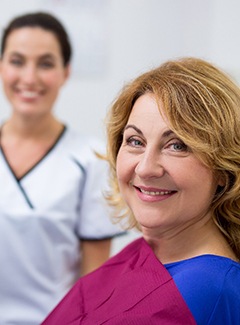 patient smiling after getting dentures 