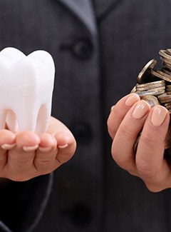 Tooth and money in hands