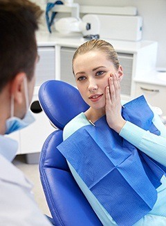 Pained woman visiting her emergency dentist in Topeka and Silver Lake