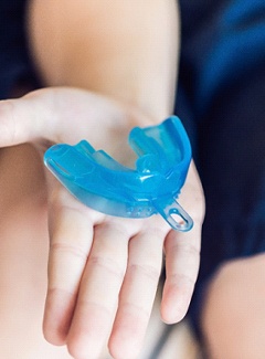 Person holding a mouthguard