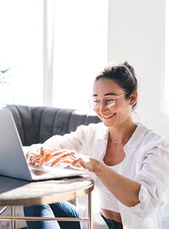 Woman smiling while working at home