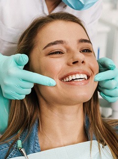 Patient smiling while looking at reflection in mirror