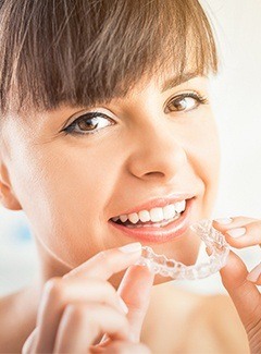 woman putting in invisalign