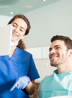 Dentist showing patient image on tablet