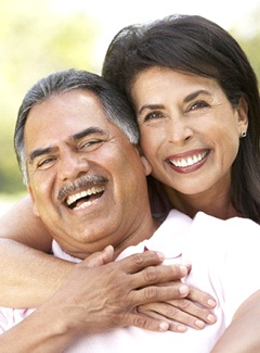 older couple smiling hugging