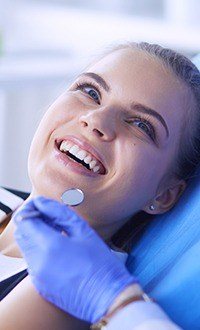 woman smiling up at dentist