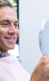 man grinning into mirror