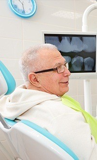 man with glasses in exam chair