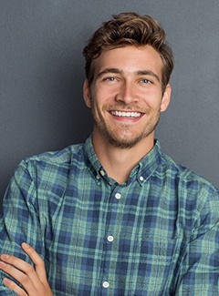 Man smiling after visiting cosmetic dentist in Topeka and Silver Lake