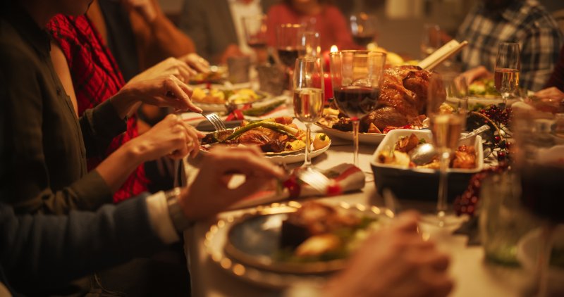 A family sitting down for a tooth-friendly holiday meal