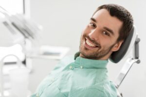 Man smiling after getting his gum disease treatment
