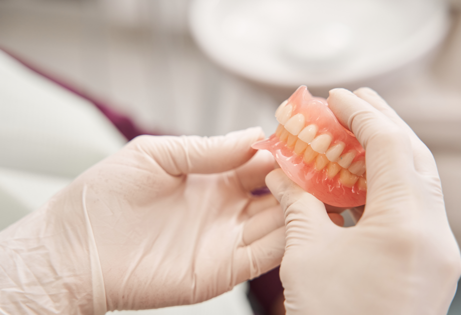 Dentist holding dentures